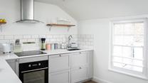 The modern kitchen is compact, but has all you need.