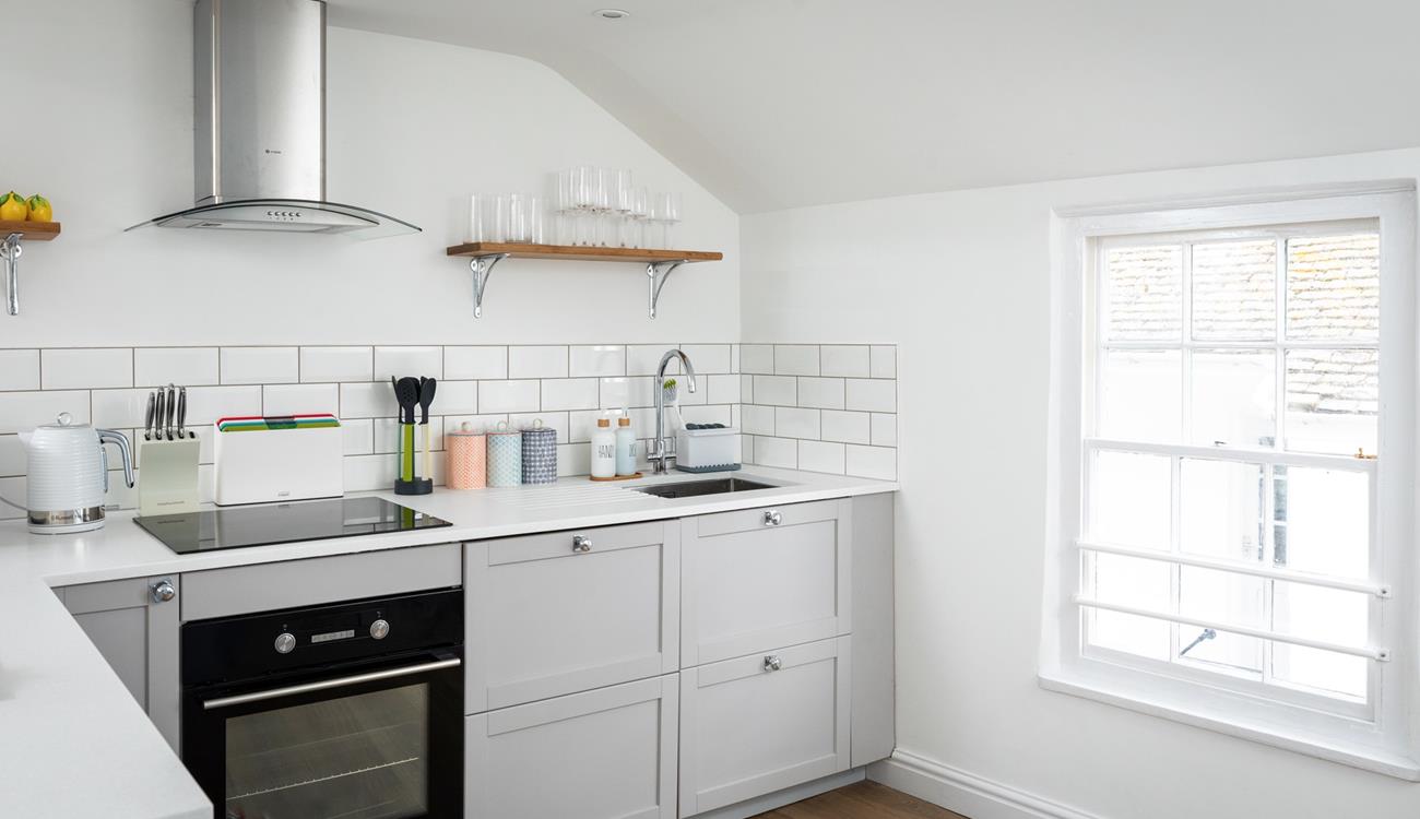 The modern kitchen is compact, but has all you need.