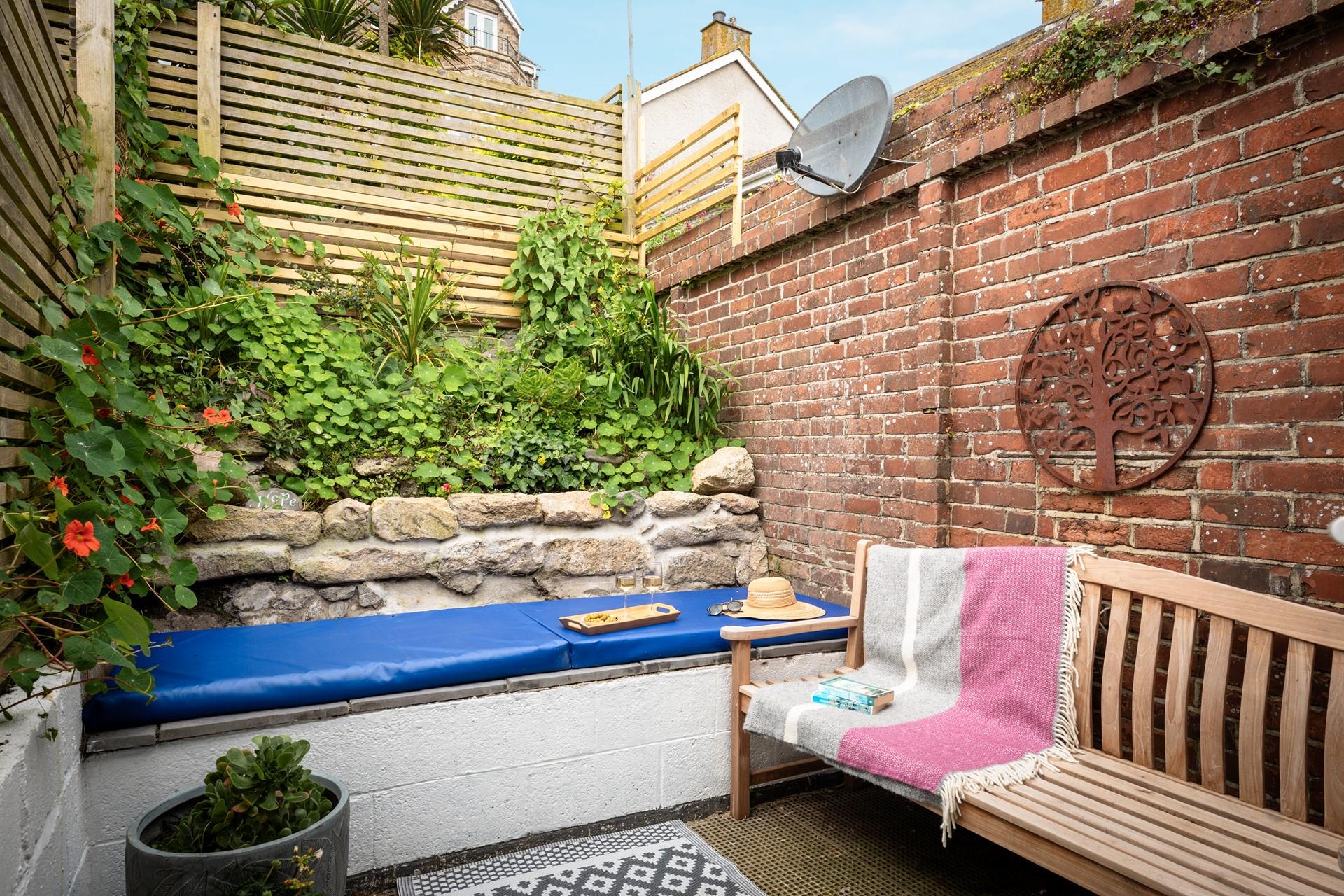 The quaint courtyard is a private suntrap.
