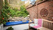The quaint courtyard is a private suntrap.