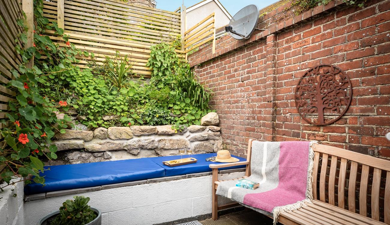The quaint courtyard is a private suntrap.