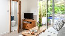 The cosy lounge is light and airy, where you can curl up after a busy day on the beach.