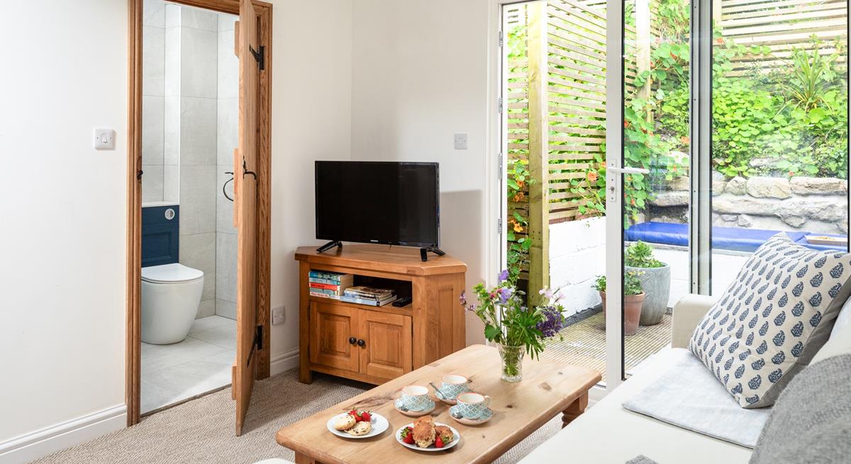 The cosy lounge is light and airy, where you can curl up after a busy day on the beach.