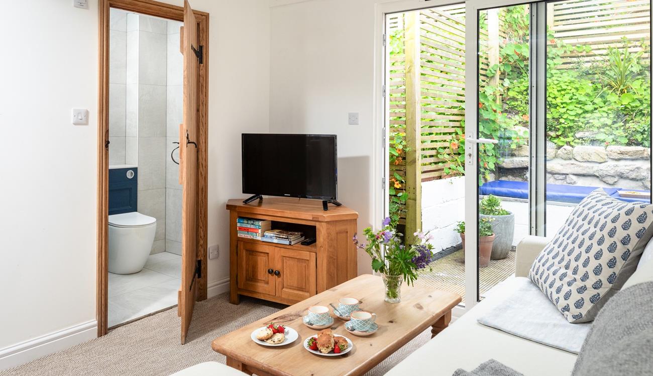 The cosy lounge is light and airy, where you can curl up after a busy day on the beach.