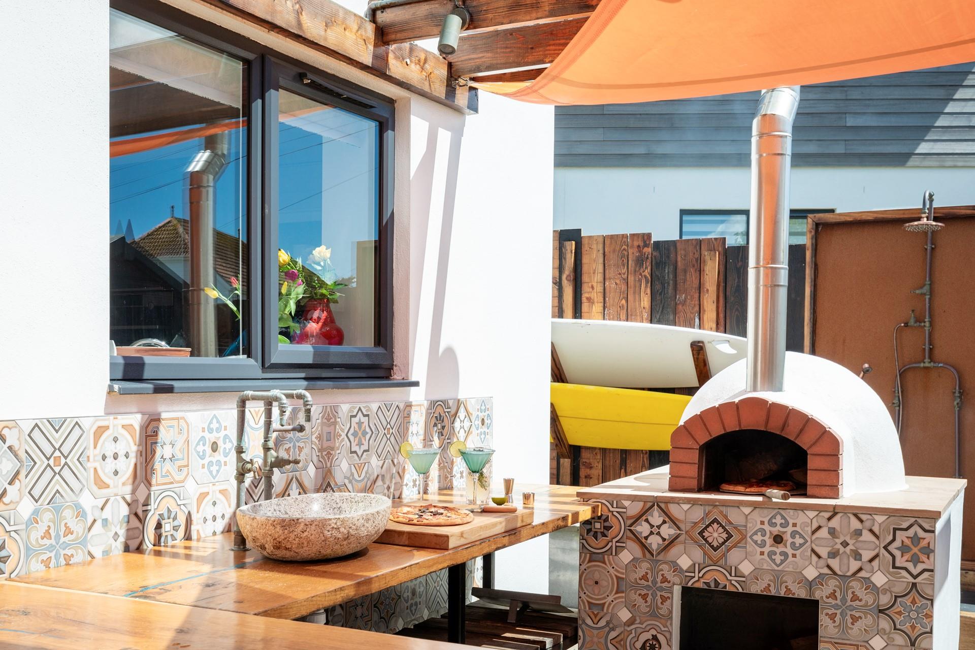 The outside kitchen area provides space to prepare a drink or two!