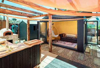 The garden room provides space to enjoy the outside area whilst seeking some shade.