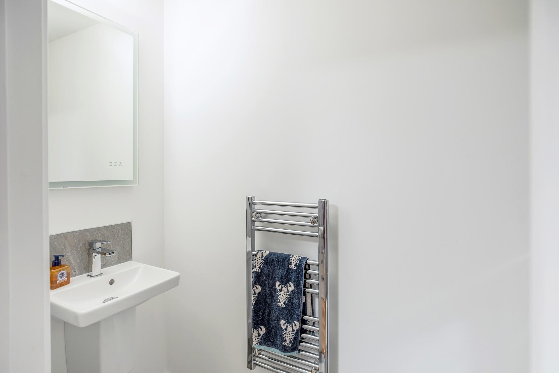 The downstairs cloakroom offers an additional WC and basin.
