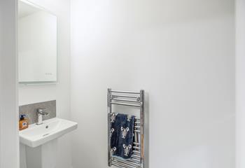 The downstairs cloakroom offers an additional WC and basin.