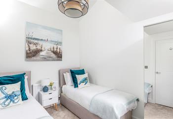The twin room is decorated in seaside blue tones.