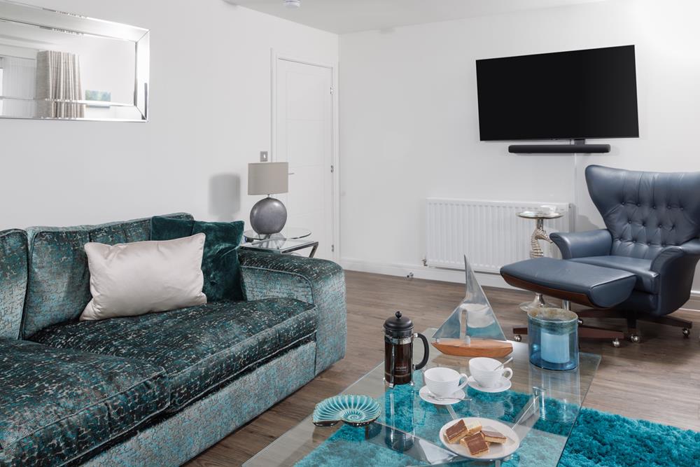 Coastal blues in the sitting area reflect the seaside location.