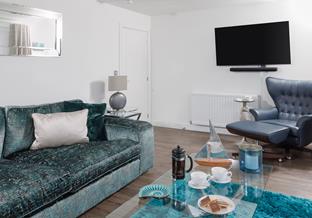 Coastal blues in the sitting area reflect the seaside location.