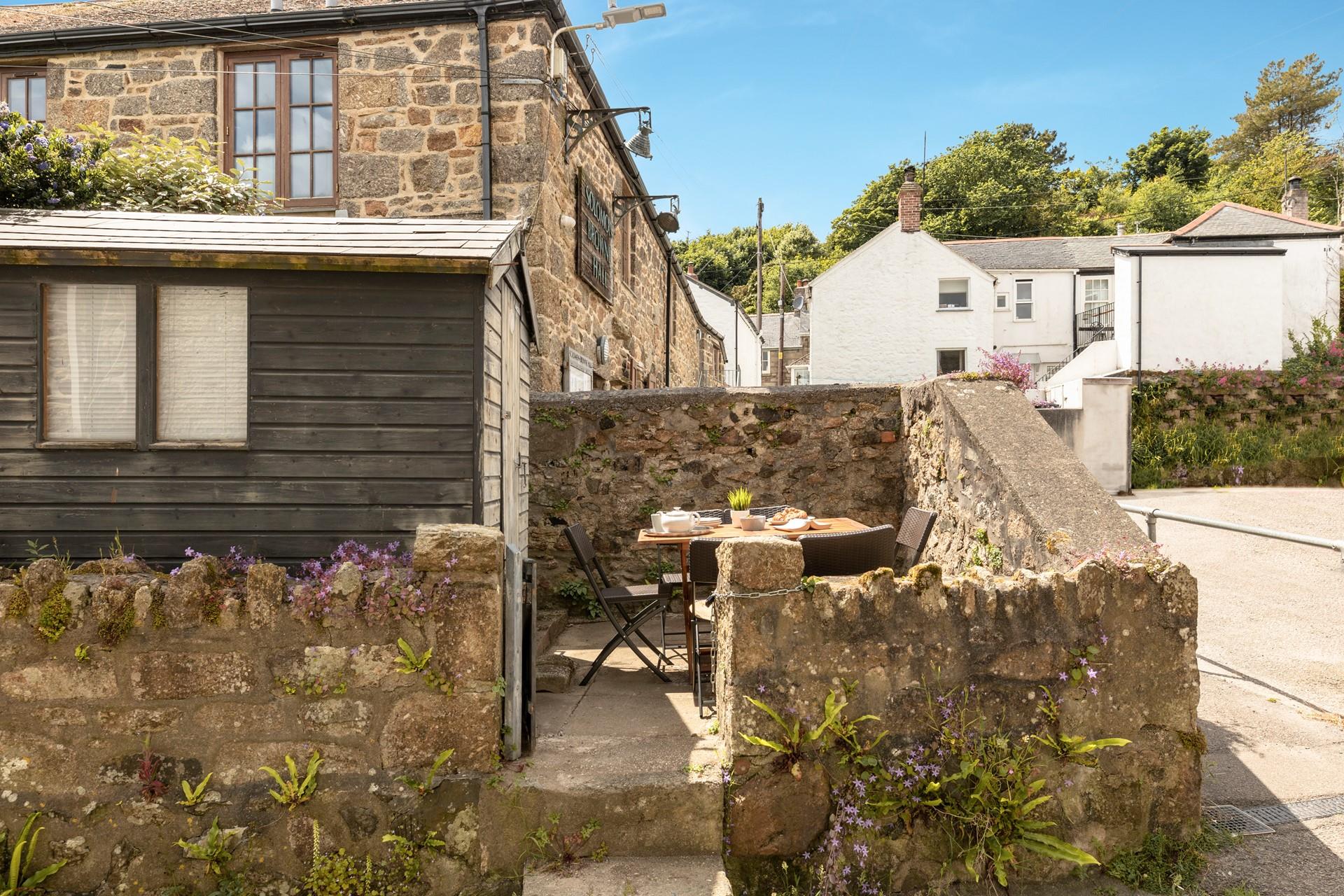 The courtyard is just opposite the cottage.