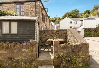 The courtyard is just opposite the cottage.