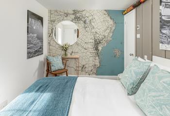 The stylish feature wall shows a map of Mousehole.
