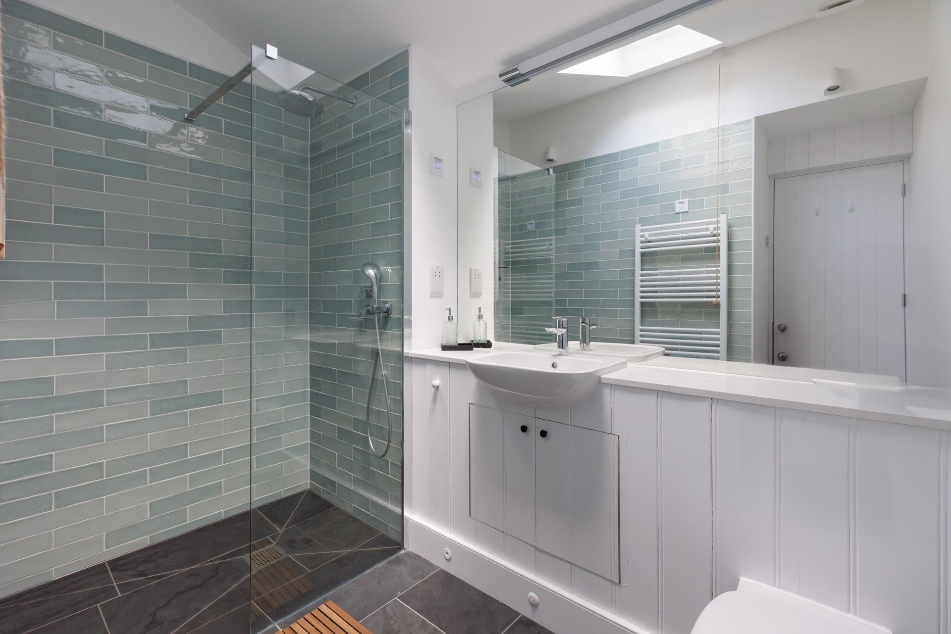 Step into the beautifully designed shower after a day of coastal exploration.