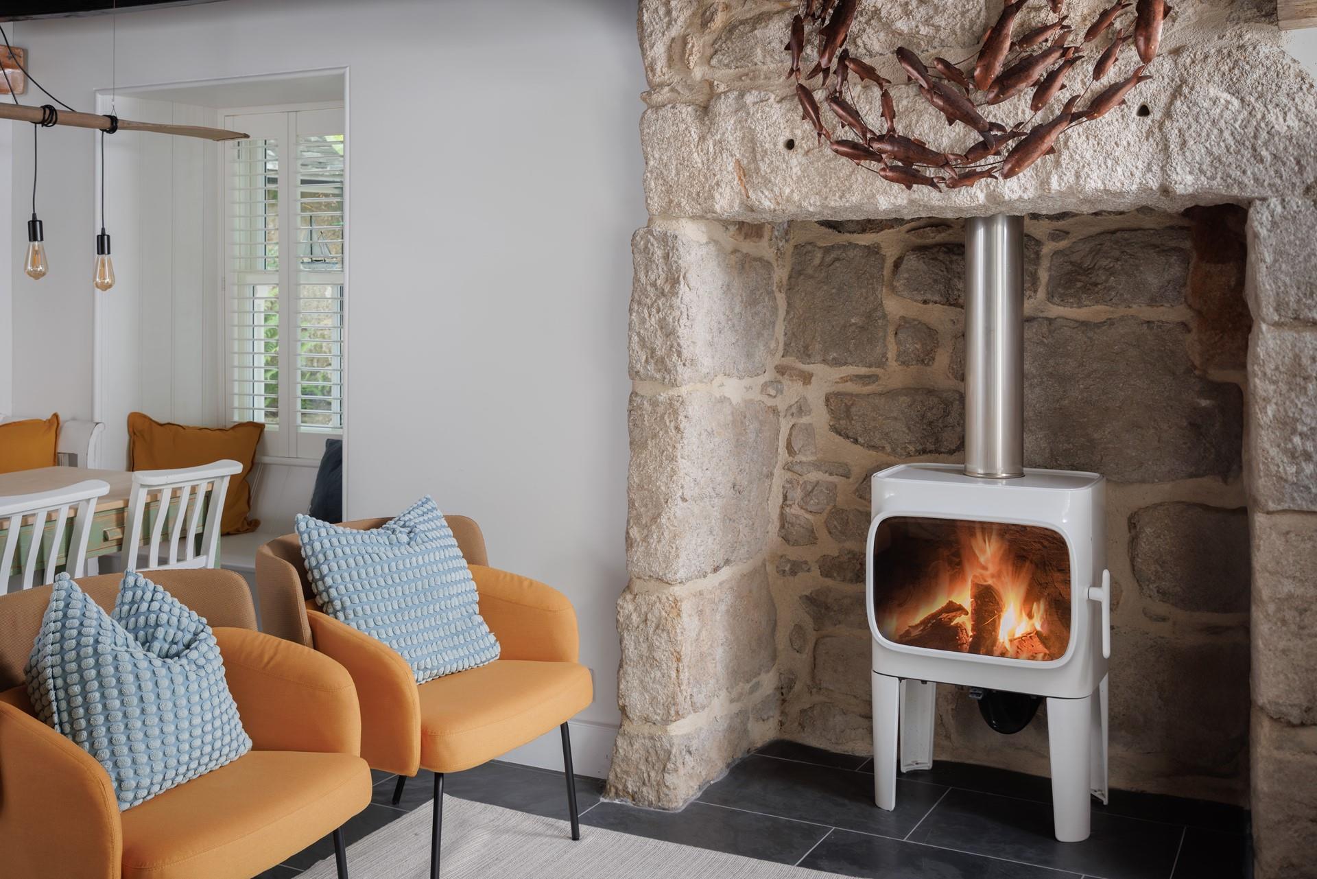 Curl up around the stylish woodburner on milder evenings.