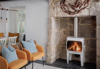 Curl up around the stylish woodburner on milder evenings.