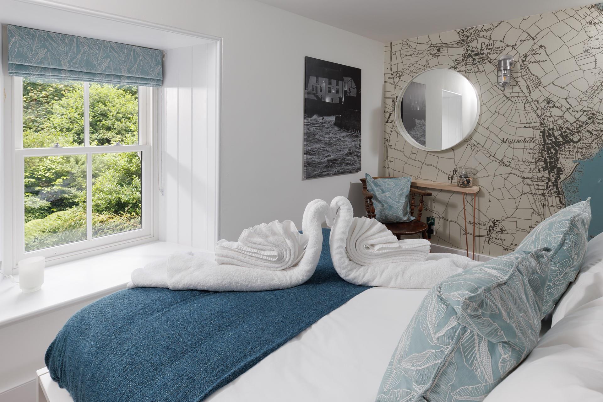 The stylish feature wall shows a map of Mousehole.