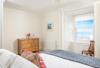 Wake up to sea views from the spacious king size bed.