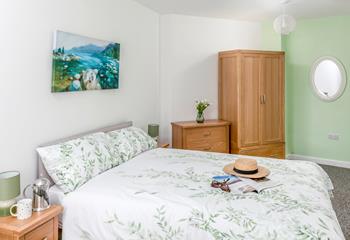 The bedroom is decorated with delightful pastel green tones.