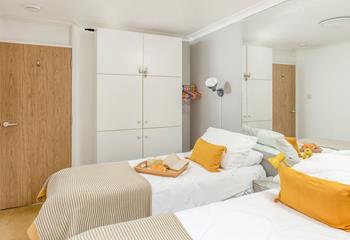 The twin room is decorated with bright pops of colour.