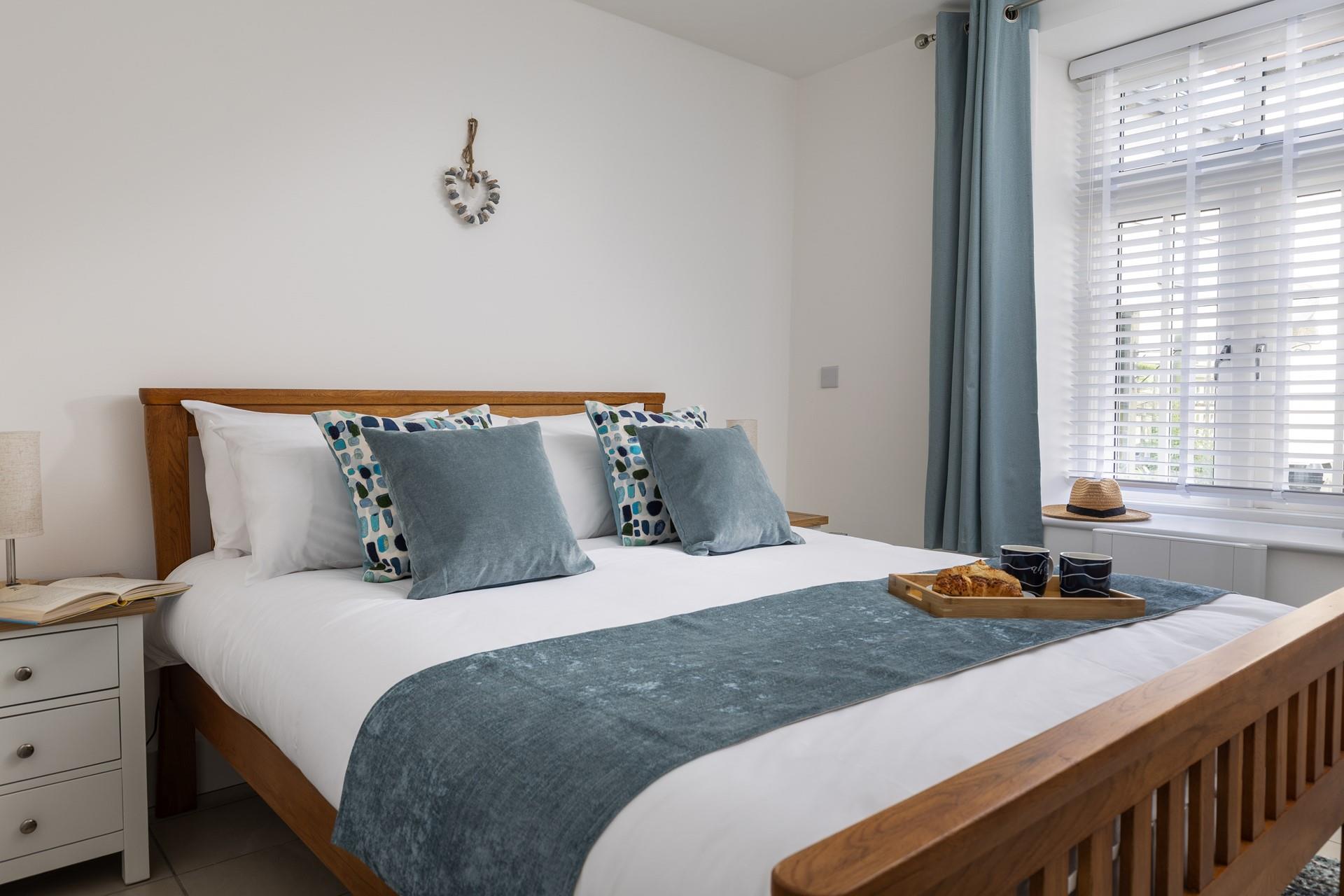 Coastal blues adorn the bedrooms, creating calming sanctuaries.