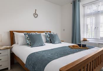 Coastal blues adorn the bedrooms, creating calming sanctuaries.
