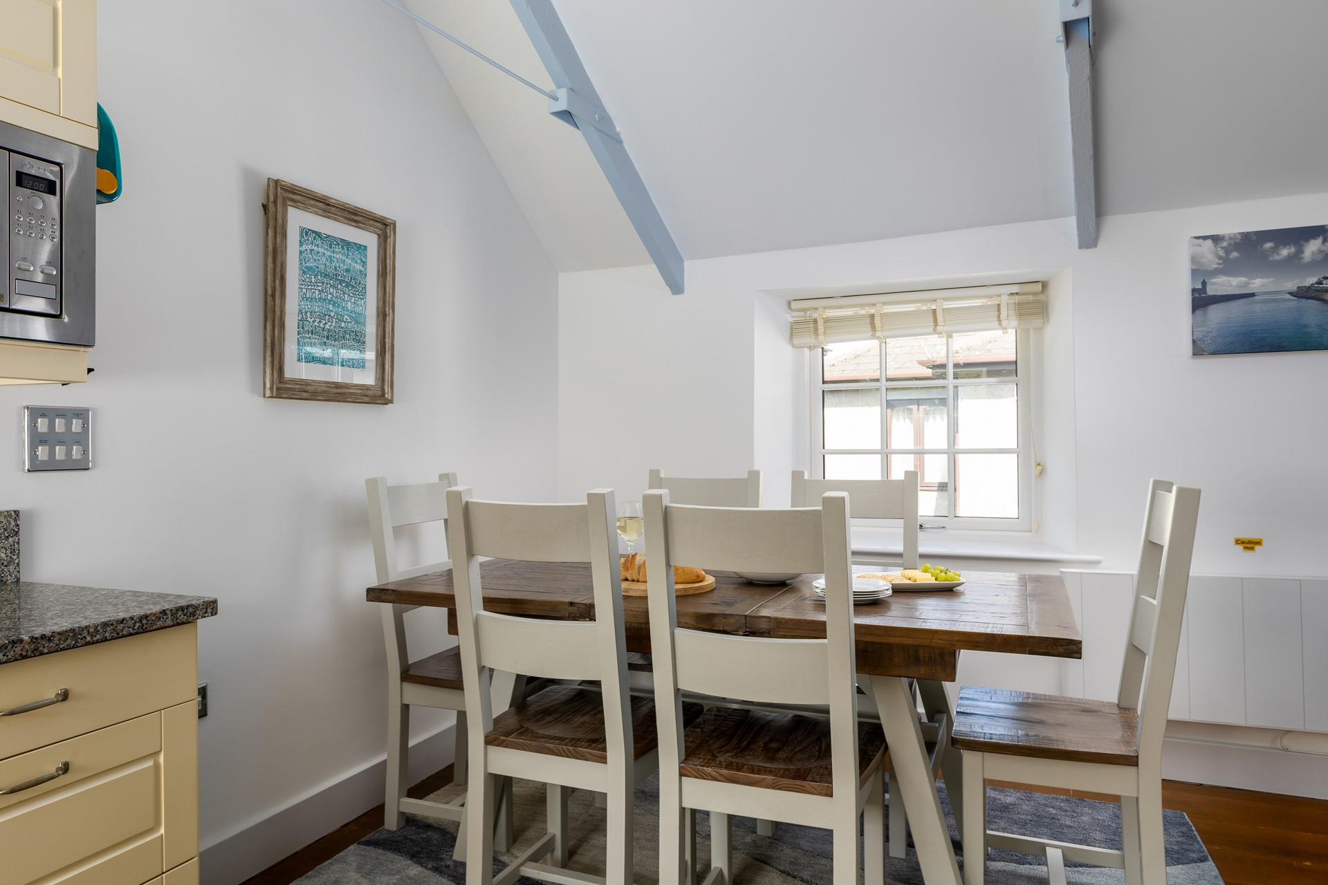 Coastal artwork is dotted around the cottage.