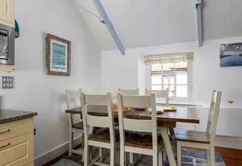 Coastal artwork is dotted around the cottage.
