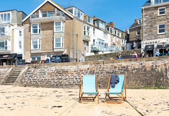 Relax on the house deck chairs on the sandy beach in front of the house. 
