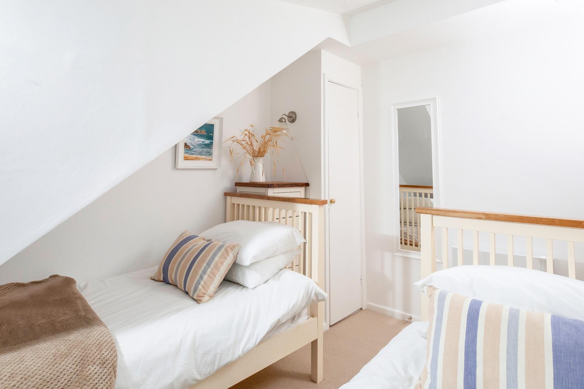 The bedrooms are simply decorated with calming tones.