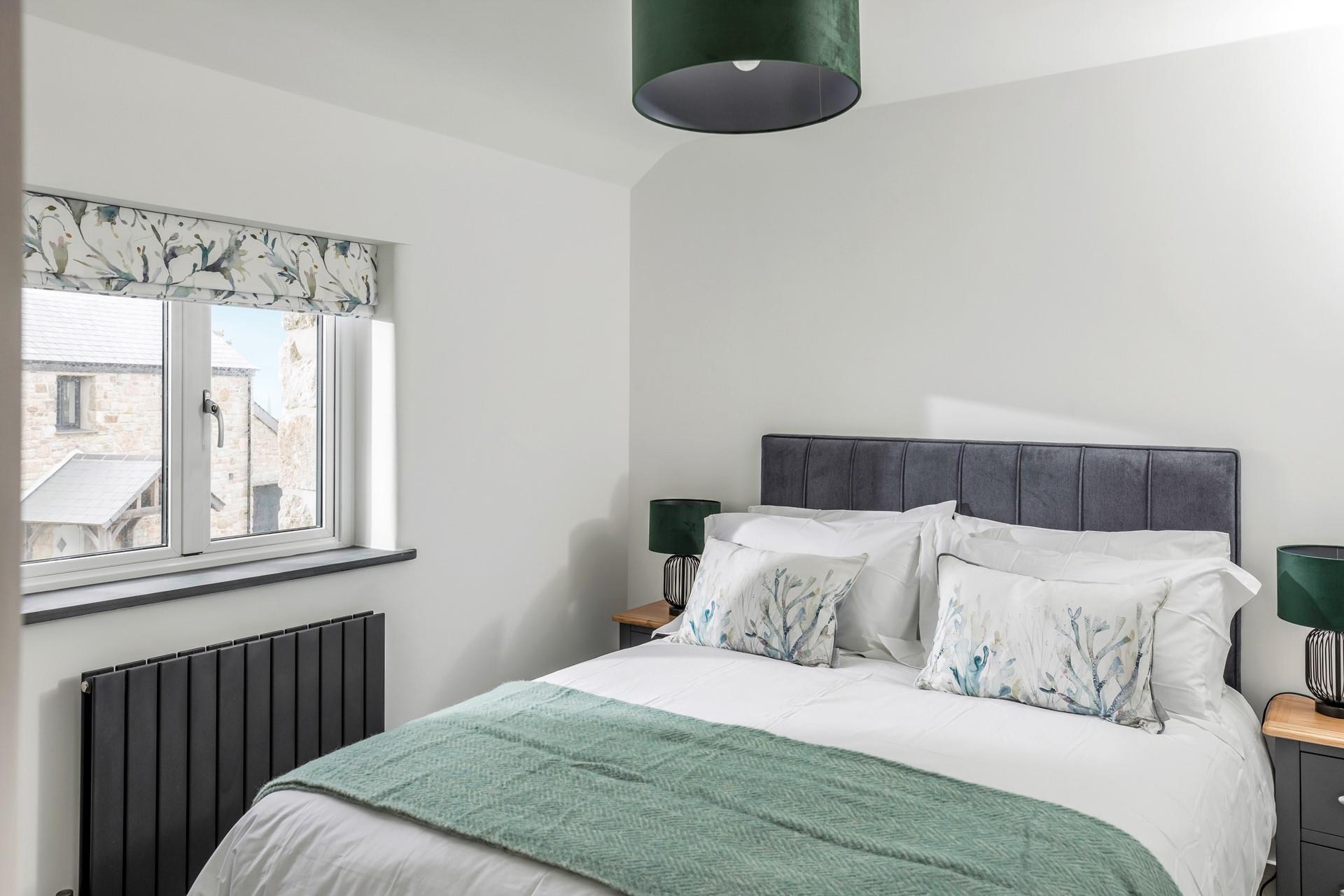 We love the stylish seaside greens in the bedroom!