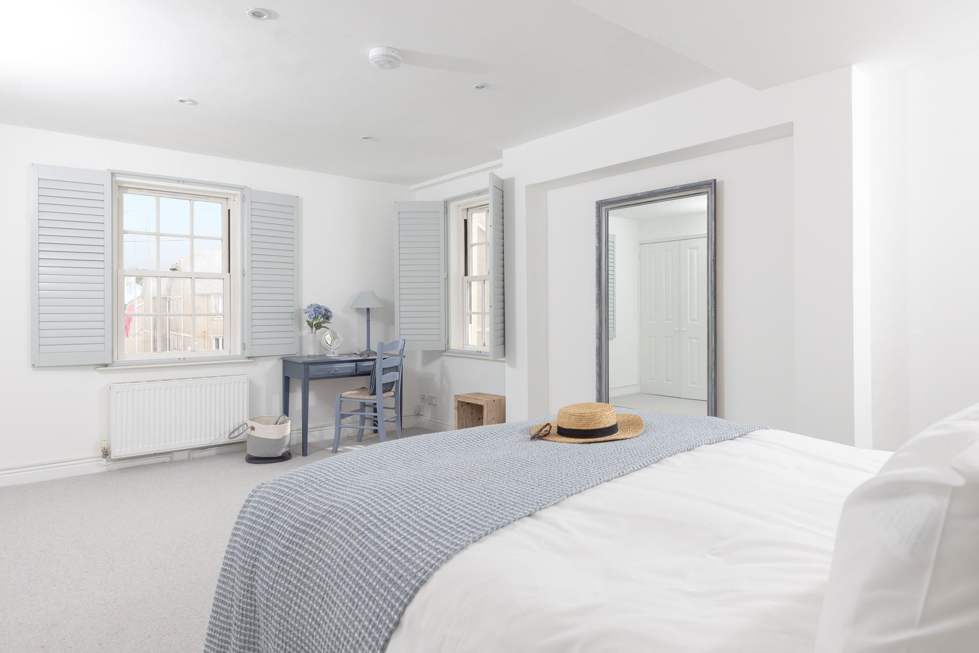 Wake up and open the shutters in this spacious bedroom.