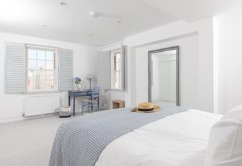 Wake up and open the shutters in this spacious bedroom.