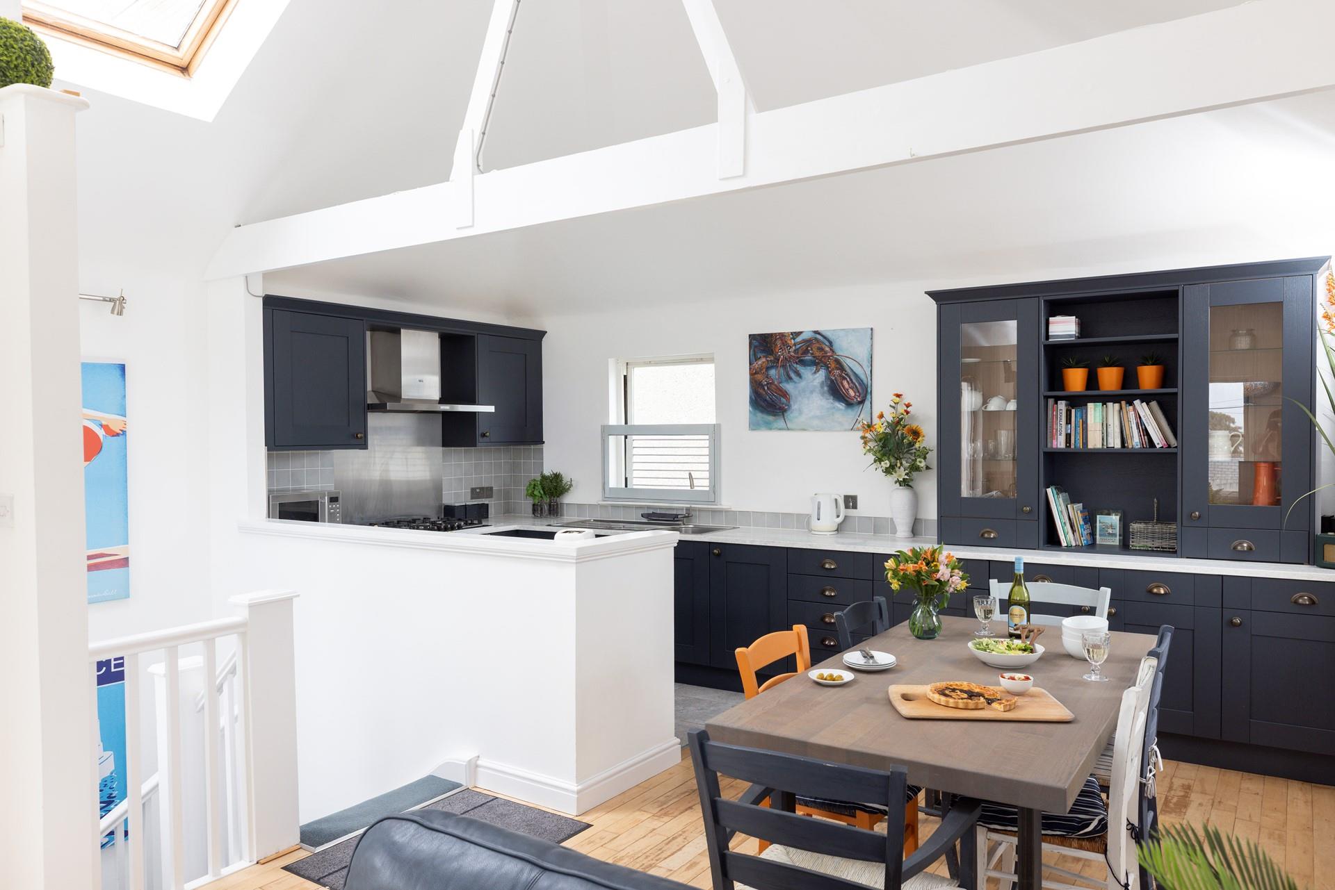The kitchen is modern and spacious featuring lovely Cornish artwork.