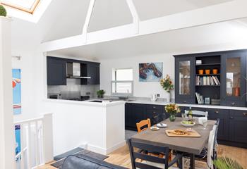 The kitchen is modern and spacious featuring lovely Cornish artwork.