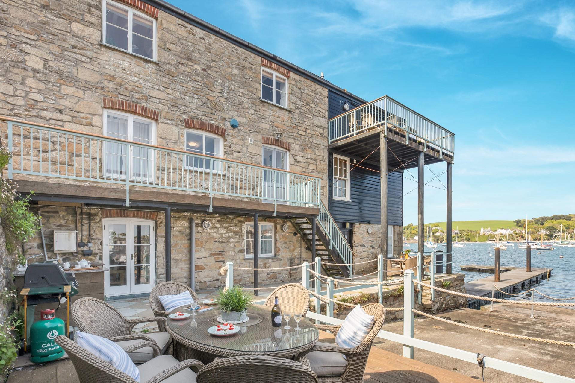 The outdoor kitchen has a sink and a barbecue.