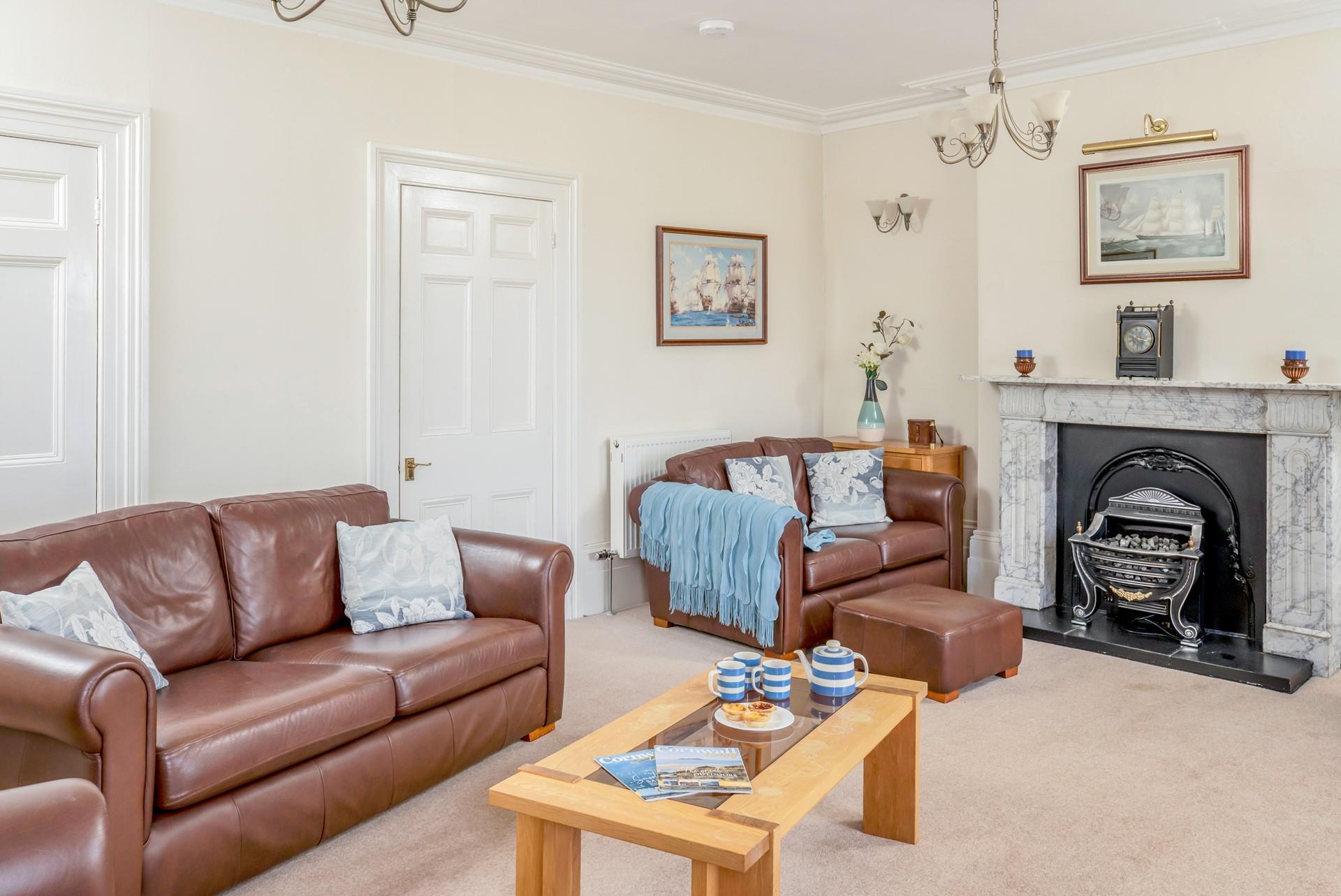 The sitting room is decorated with nautical artwork reflecting the harbourside location.