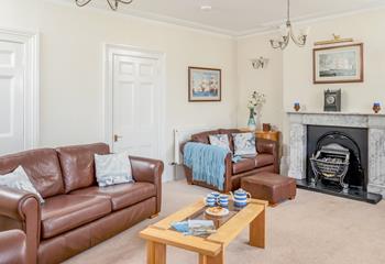 The sitting room is decorated with nautical artwork reflecting the harbourside location.