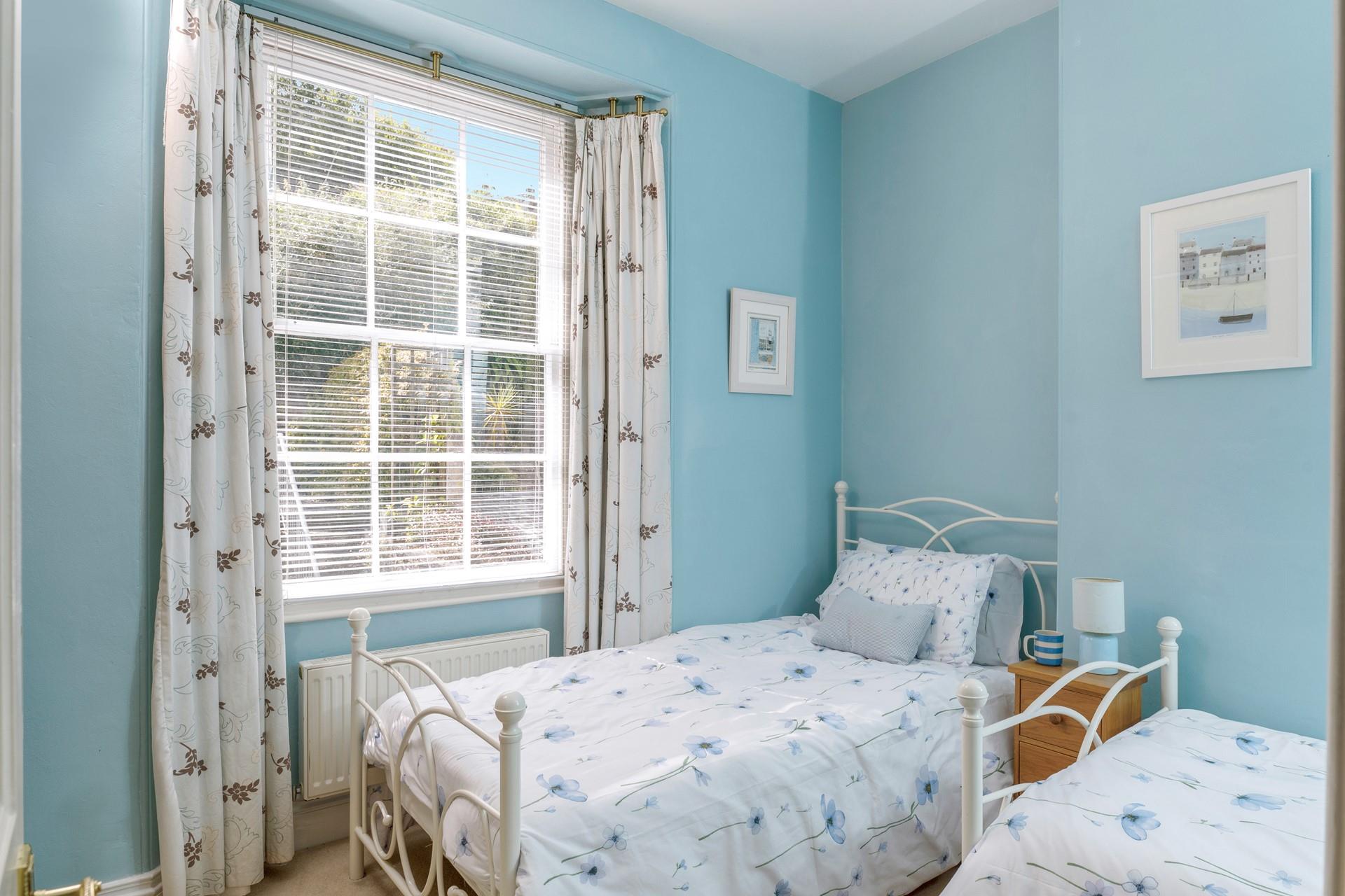Twin room is decorated with coastal blues.