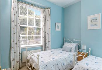 Twin room is decorated with coastal blues.