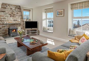 The homely sitting room offers stunning views across Porthleven.