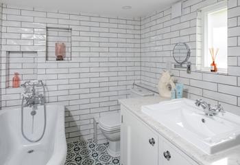 The gorgeous bathroom offers a luxurious slipper bath.