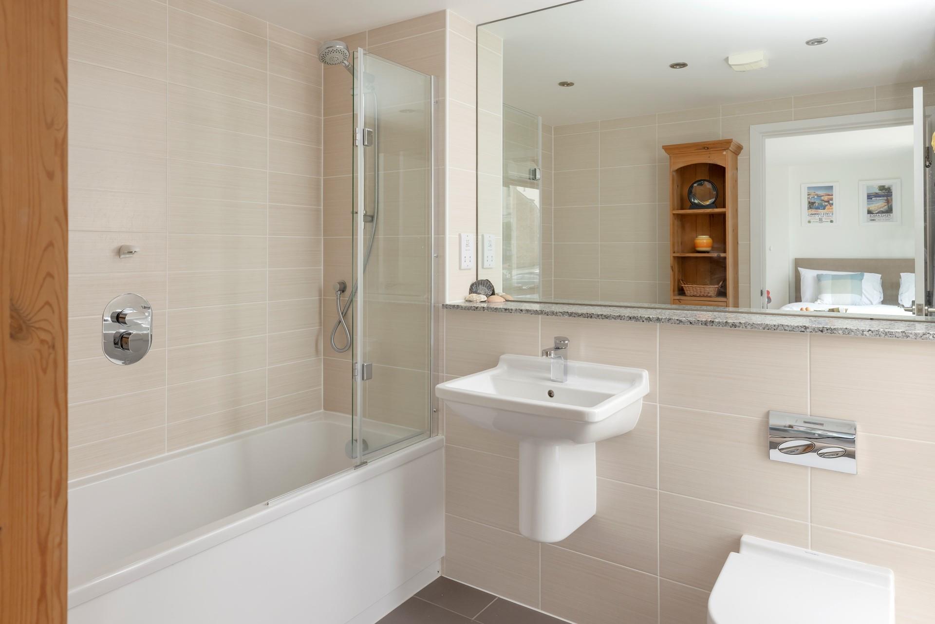 The en suite has a bath and a shower for getting ready each day.