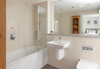 The en suite has a bath and a shower for getting ready each day.