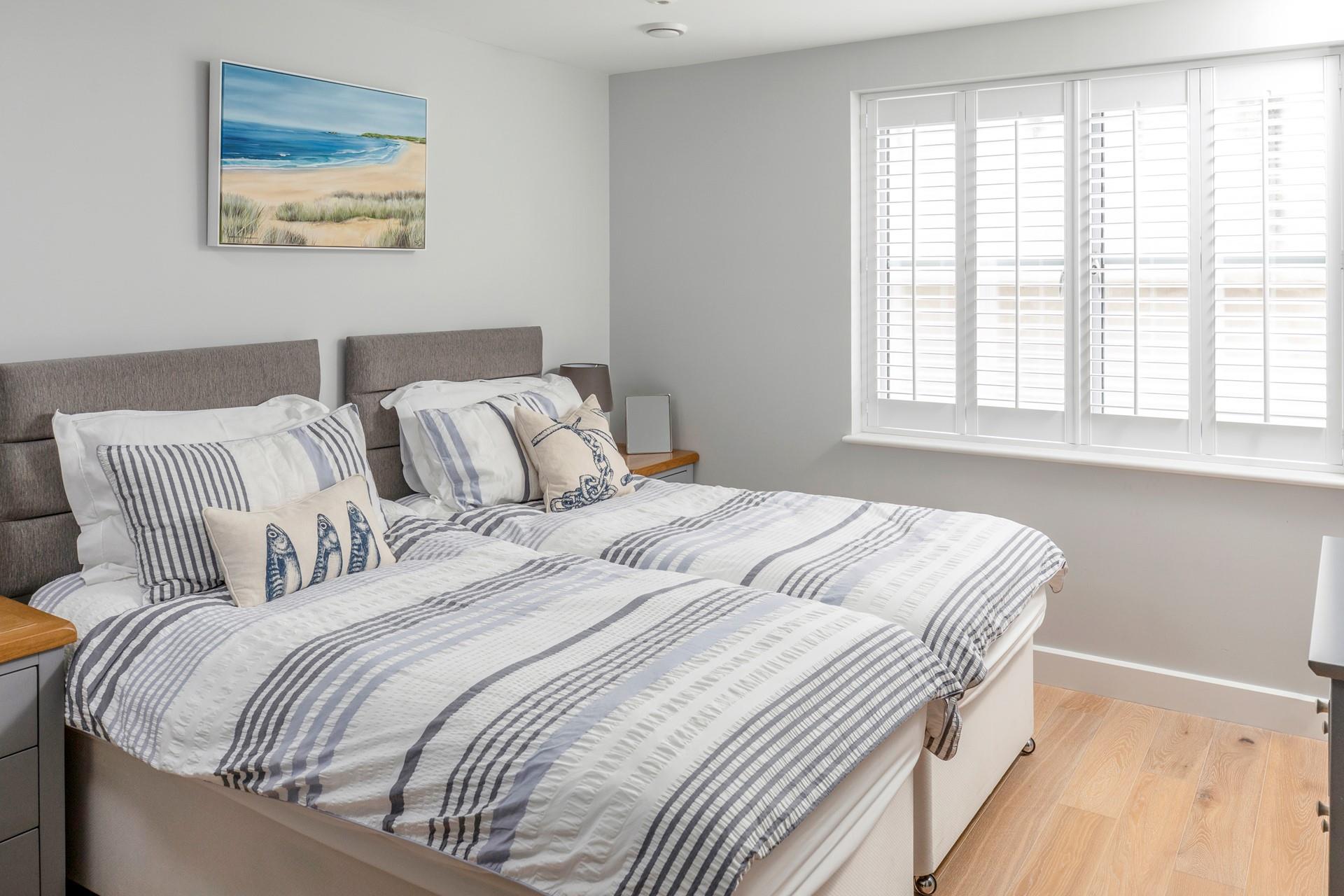 Bedroom 2 has twin beds and allows for flexible sleep arrangements.