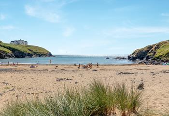 Take a morning dip in the calm waters of Poldhu Beach.