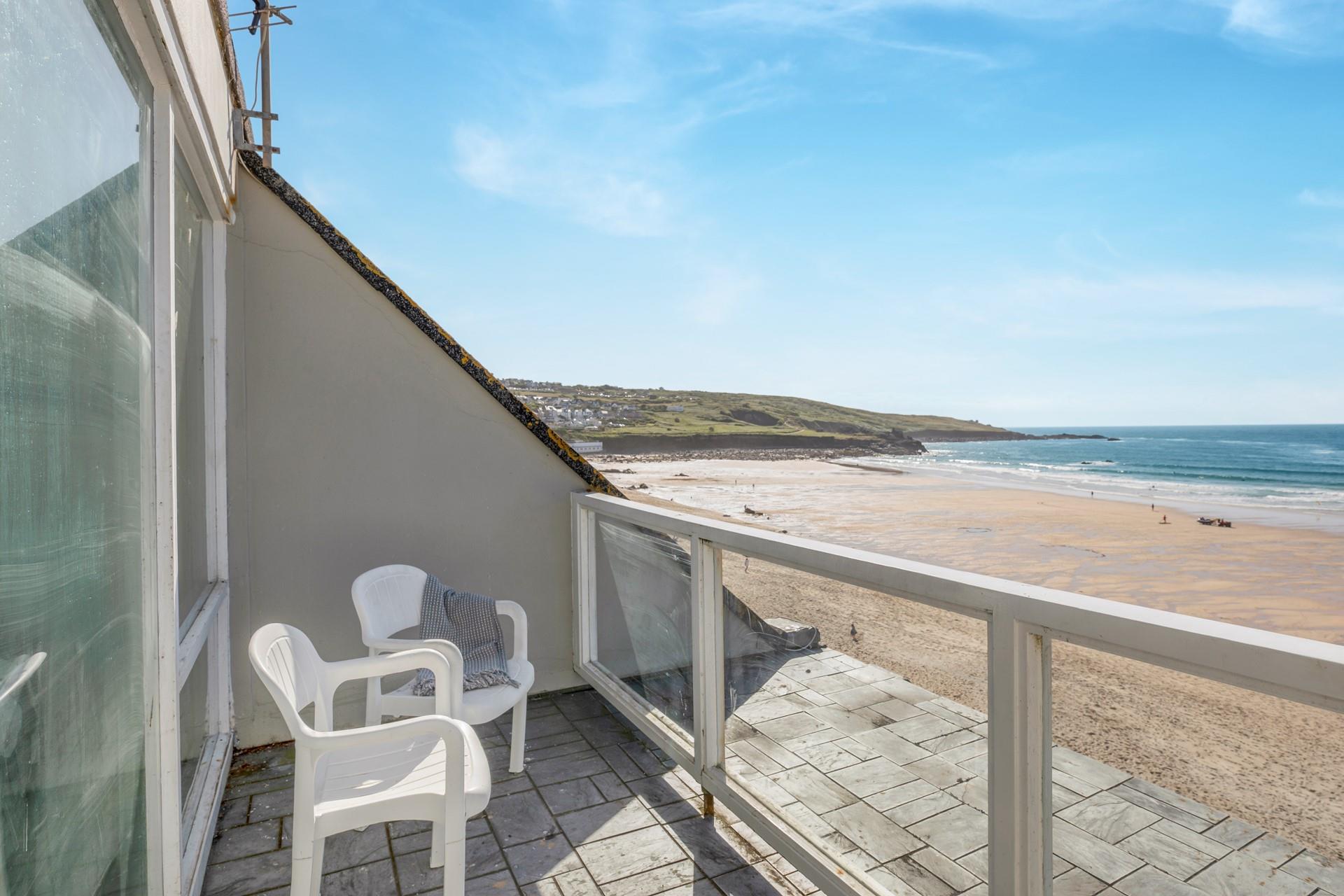 Watch the sunset from the balcony over the beach.