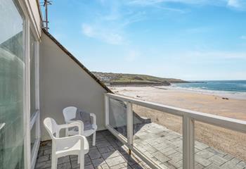 Watch the sunset from the balcony over the beach.