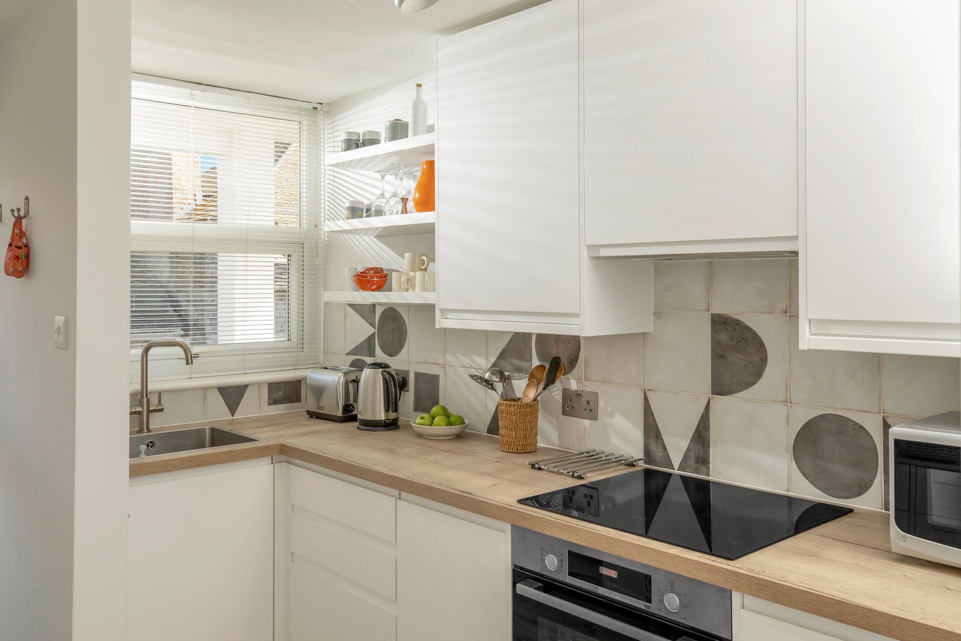 The kitchen is modern and stylish for preparing meals.